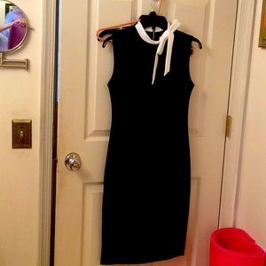 Black sheath with contrast collar and bow.